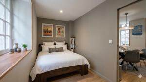 a small bedroom with a bed and a desk at KENDALL in Saint Malo
