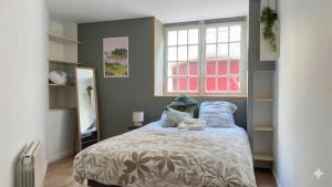 a bedroom with a bed and a window at KENDALL in Saint Malo +12 photos