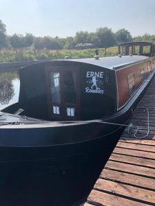 a black boat is docked at a dock at The Erne Rambler in Silverhill +5 photos