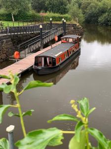a boat is docked next to a dock at The Erne Rambler in Silverhill