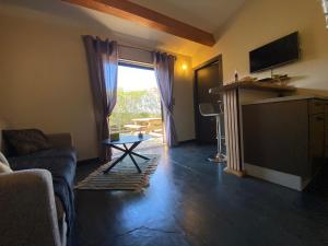 a living room with a couch and a large window at Résidence Petru-Maria in Propriano