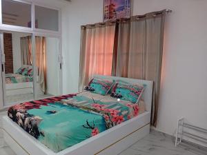 a bed in a room with a window at Continental in Komé