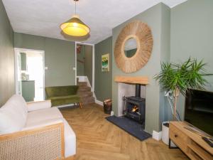 a living room with a couch and a fireplace at Cheshire Views in Malpas