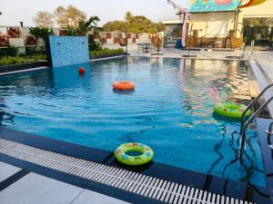 a swimming pool with inflatable balls in the water at IR Resorts Mahasamund in Mahāsamund +5 photos
