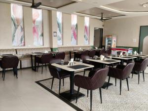 a restaurant with tables and chairs in a room at IR Resorts Mahasamund in Mahāsamund