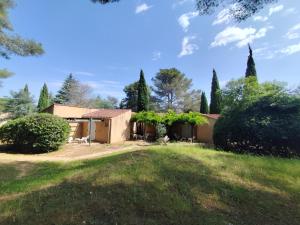 a house in the middle of a yard at Village Vacances La Manne in Bormes-les-Mimosas