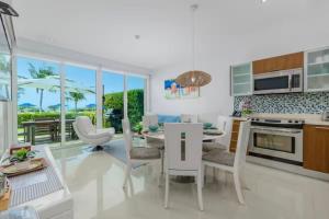 a kitchen and living room with a table and chairs at Apartment in paradise on the happy island of ARUBA, beachfront in Savaneta