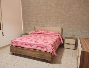 a bedroom with a bed with a pink blanket at Casina del Sole - Rho Fiera Milano in Bollate
