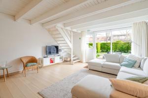 a living room with a white couch and a table at Aalduiker 7 in Nieuwpoort