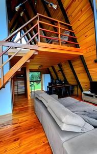 a large bed in a room with a wooden ceiling at Lakefront Chalet, hot tub, heated bathtub and waterfall in Alexânia