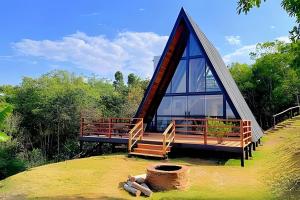 a house with a dome roof with a staircase and a deck at Lakefront Chalet, hot tub, heated bathtub and waterfall in Alexânia