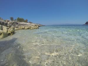 a body of water with rocks and the ocean at Holiday house Karla in Vela Luka