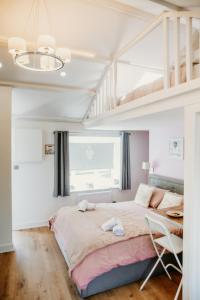 a bedroom with a large bed and a loft at Robyns Retreat in Brynsiencyn