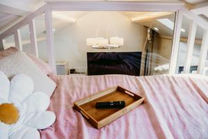a remote control sitting on top of a bed at Robyns Retreat in Brynsiencyn