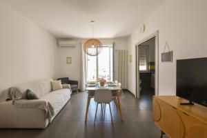 a living room with a couch and a table at Levante Sea View Apartment - Housea in Polignano a Mare