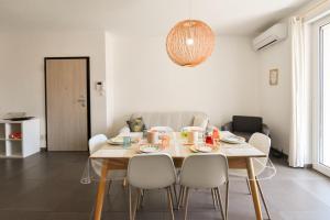 a dining room with a table and chairs at Levante Sea View Apartment - Housea in Polignano a Mare
