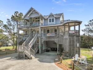 a large house with a staircase in front of it at WV09 Play Time in Waves