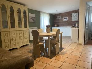 a kitchen and dining room with a table and chairs at Relais Le Folaghe in Ladispoli