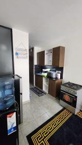 a kitchen with a stove and a refrigerator at nook in Ongata Rongai 