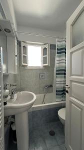 a bathroom with a sink and a tub and a toilet at Blue House Naxos in Naxos Chora +23 photos