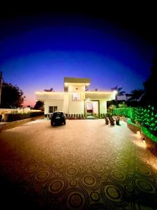 a car parked in front of a large building at Mango People Farm in Gurgaon