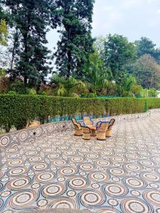 two chairs sitting on a patterned tile floor at Mango People Farm in Gurgaon