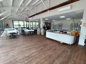 a large room with tables and chairs and a cafeteria at Village Vacances La Manne in Bormes-les-Mimosas