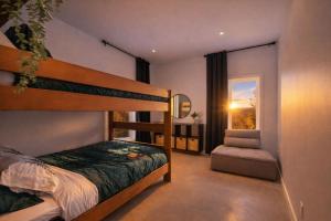 a bedroom with a bunk bed and a window at Havre du Mont in Saint Come
