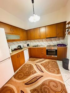 a kitchen with a large rug on the floor at Dryrivers house in Xiropótamos
