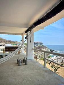 a balcony with a view of the beach at Casa PuntaBlanca in Puerto Ángel