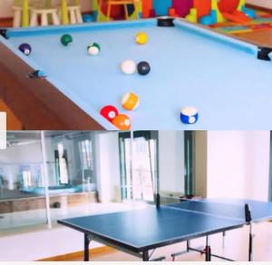 a ping pong table with balls on top of it at Playa Reinante SPA in Barreiros