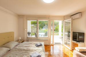 a bedroom with a bed and a sliding glass door at Apartments M&M Portorož in Lucija