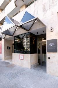 a building with a large window on the side of it at Apartamentos Plaza España - Enjoy Sevilla in Seville