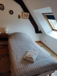 a bedroom with a bed in a attic with a window at maison entière in Fécamp