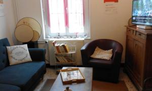 a living room with a couch and a chair at maison entière in Fécamp