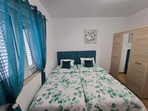 a bedroom with a bed with blue drapes at Apartment Angel in Kotor
