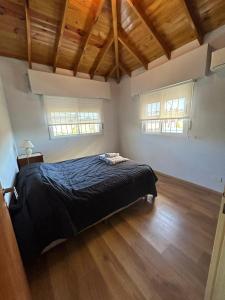 a bedroom with a bed in a room with wooden floors at Departamento Martinez in Martínez