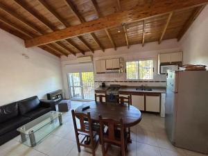 a kitchen and living room with a wooden ceiling at Departamento Martinez in Martínez