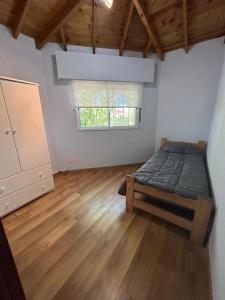 a bedroom with a bed and a window at Departamento Martinez in Martínez