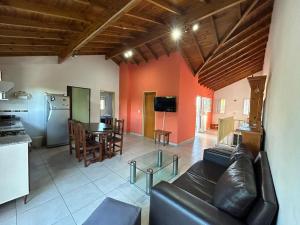 a living room with a leather couch and a table at Departamento Martinez in Martínez
