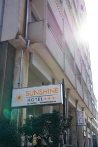 a sign for a hotel on the side of a building at Sunshine HOTEL in Mestre