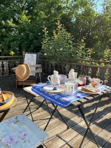 a table with a tea set on a deck at Gästezimmer Flora Hanauerland - Kunst & Natur nahe Straßburg in Kehl am Rhein +13 photos