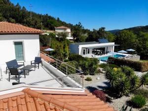 a house with a patio and a swimming pool at Casa Carvalhal - Adults Only in Góis