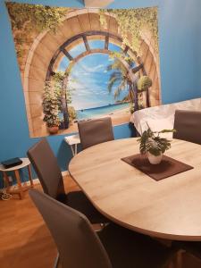 a dining room with a table and a painting of a beach at Casino in Dieppe