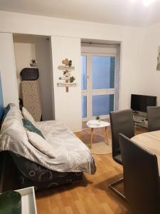 a bedroom with a bed and a table and a window at Casino in Dieppe