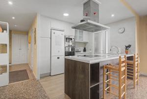 a kitchen with a sink and a refrigerator at Apartamento en Cullera in Cullera +20 photos