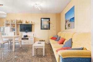 a living room with a couch and a table at Apartamento en Cullera in Cullera
