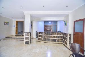a lobby with a stone counter in a building at Hôtel Atlas in Tangier