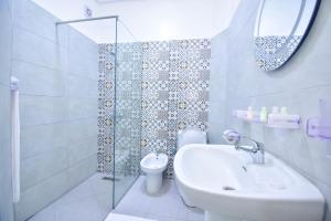 a bathroom with a sink and a toilet at Hôtel Atlas in Tangier +122 photos