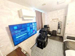 a room with a waiting room with chairs and a flat screen tv at セルフプラスホテル銚子無人ホテル in Choshi +34 photos